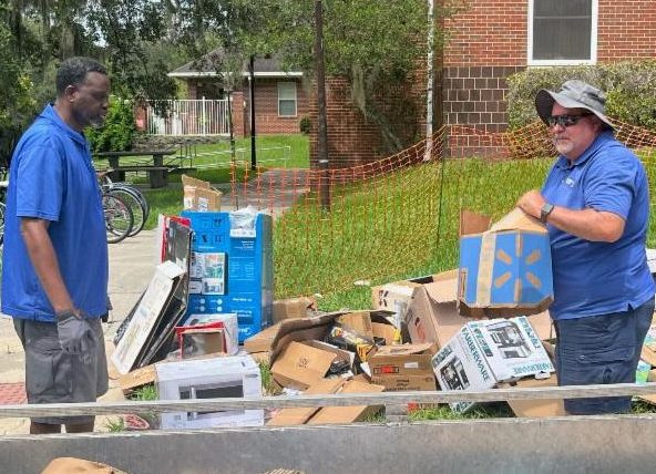 Facilities Services staff members work to divert cardboard boxes to recycling.